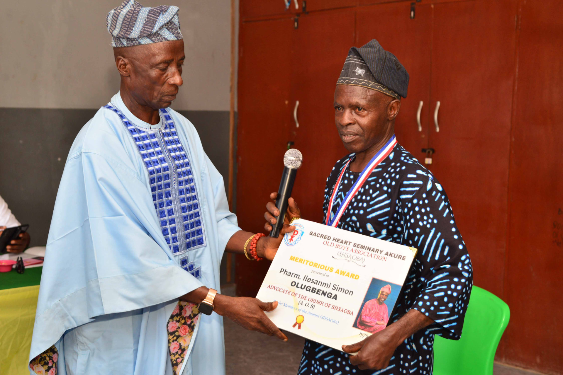 Pharm. Ilesanmi Simon Olugbenga receiving his Meritorious Award certificate