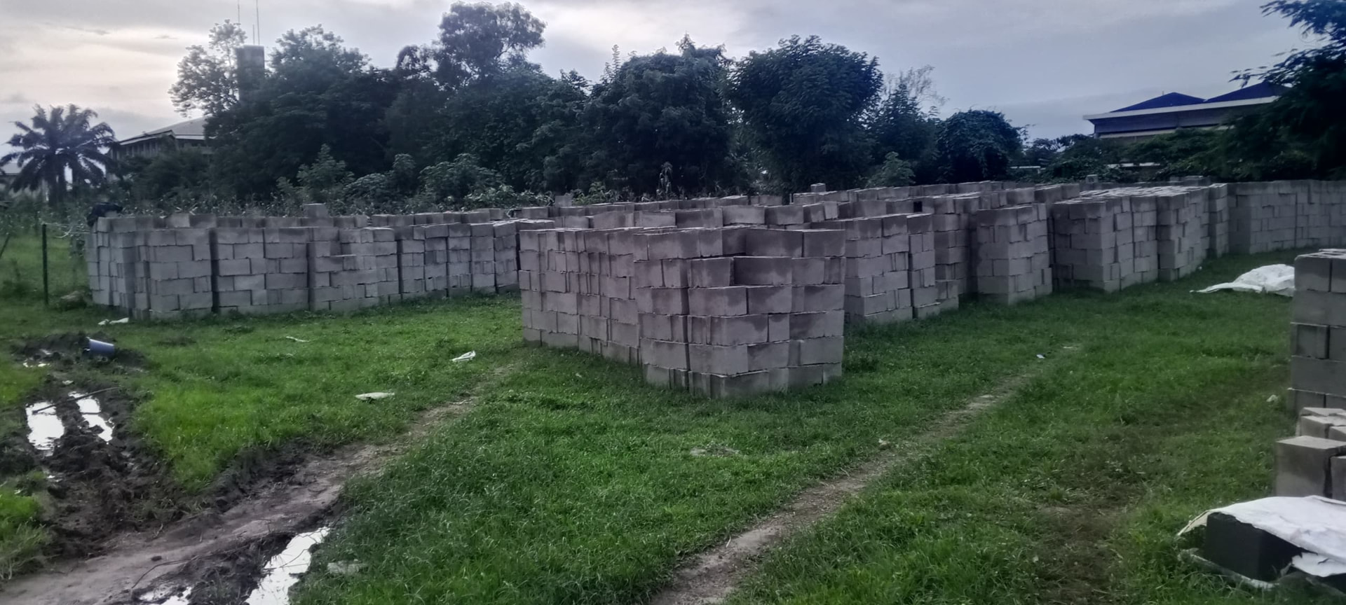 Thousands of moulded concrete blocks stacked in rows on the SHSAOBA building site