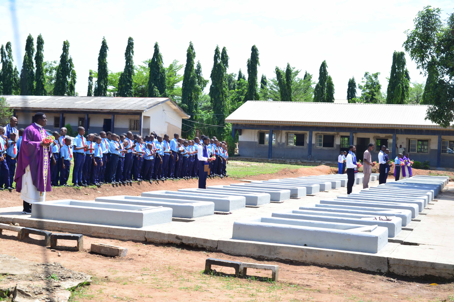 Priest and seminarians at the graveside blessing during the Alumni Day Requiem Mass