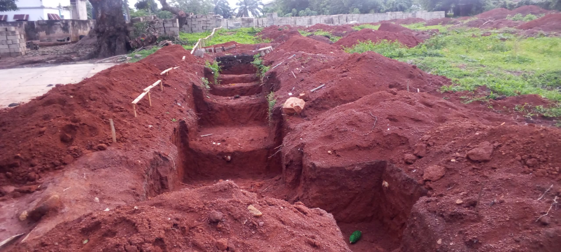 Foundation excavation at the SHSAOBA building site — Terraced foundation trench with profile pegs set out