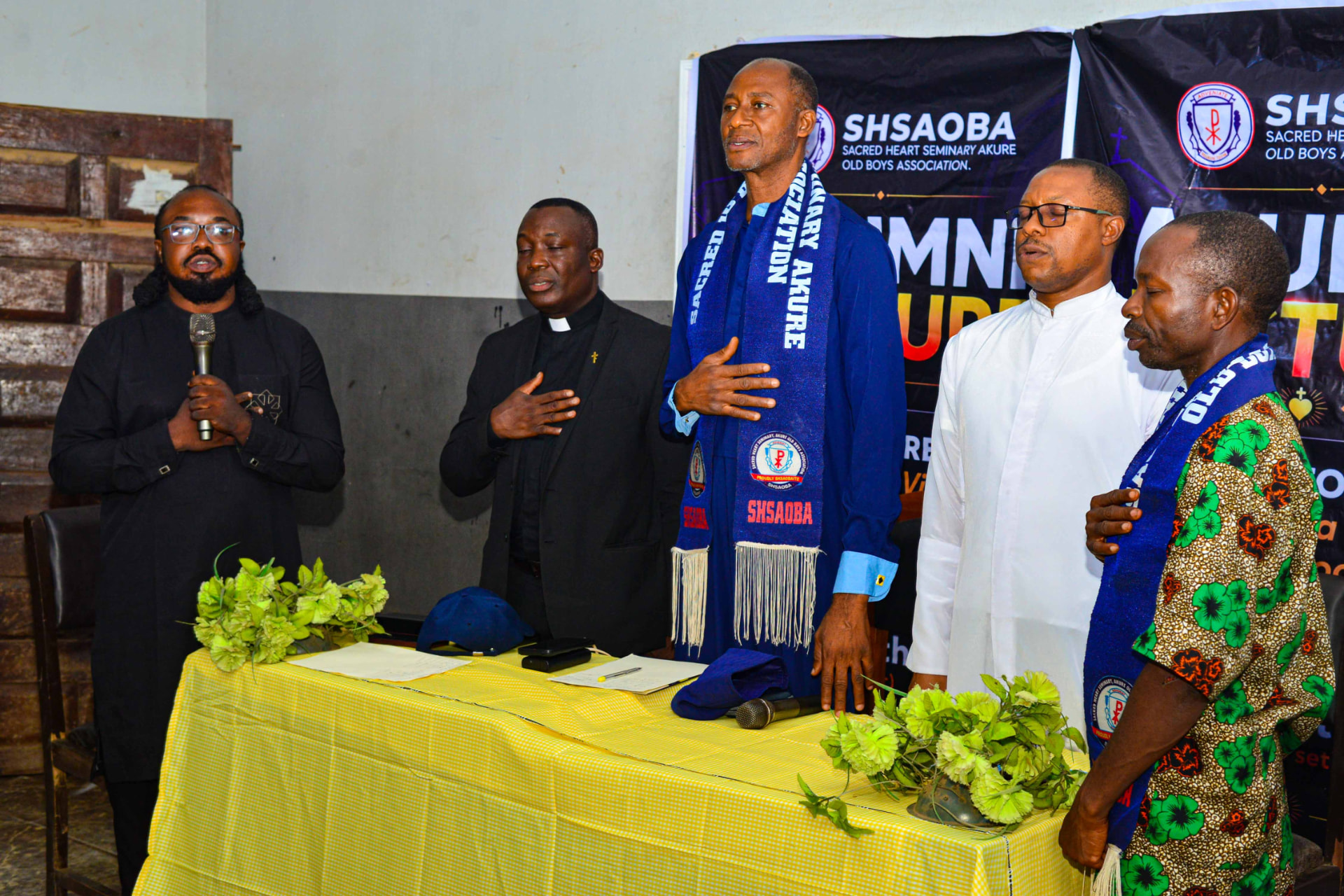 SHSAOBA members and clergy standing together at the Annual Reunion 2026 induction gathering
